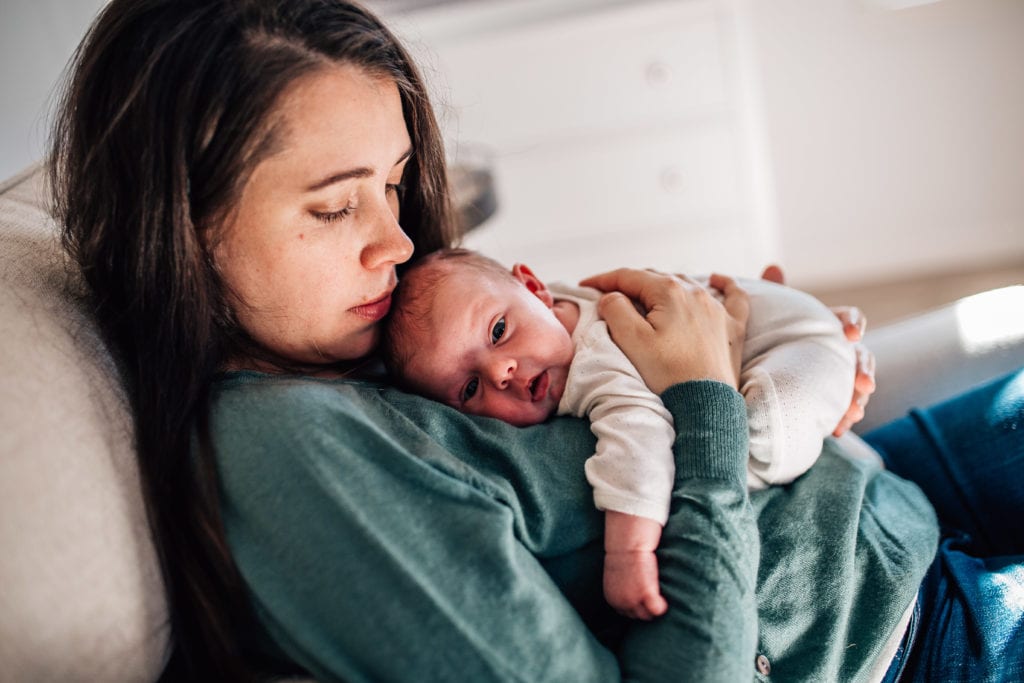 Mom holding baby in photo by sudbury newborn photographer
