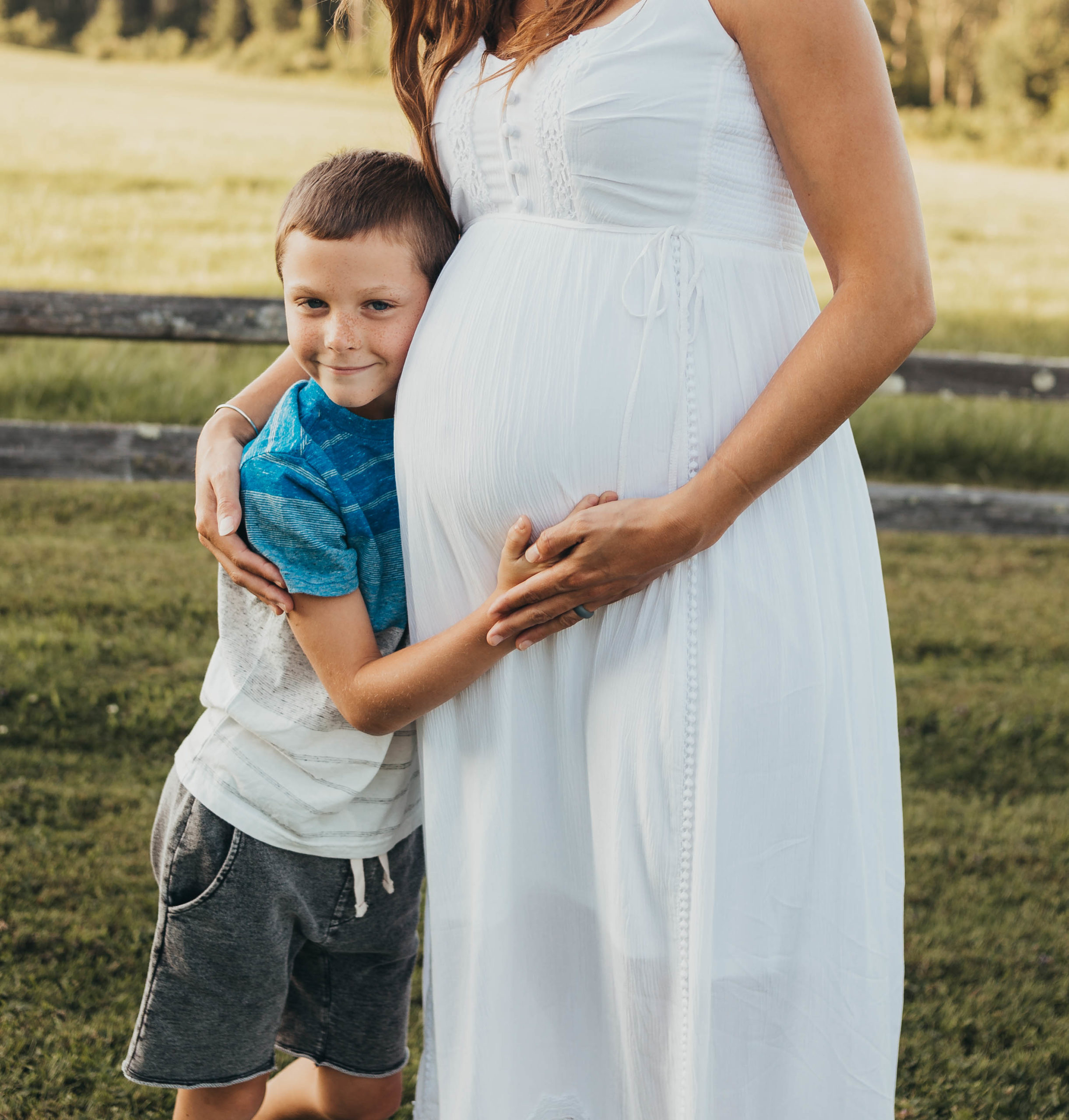 Boy hugging his mom during boston maternity session