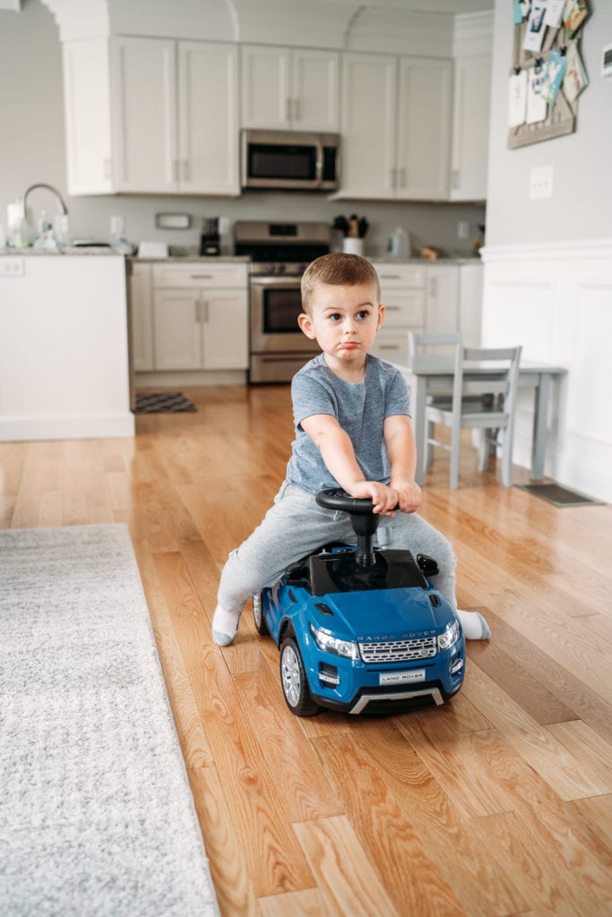 boy riding on a toy car