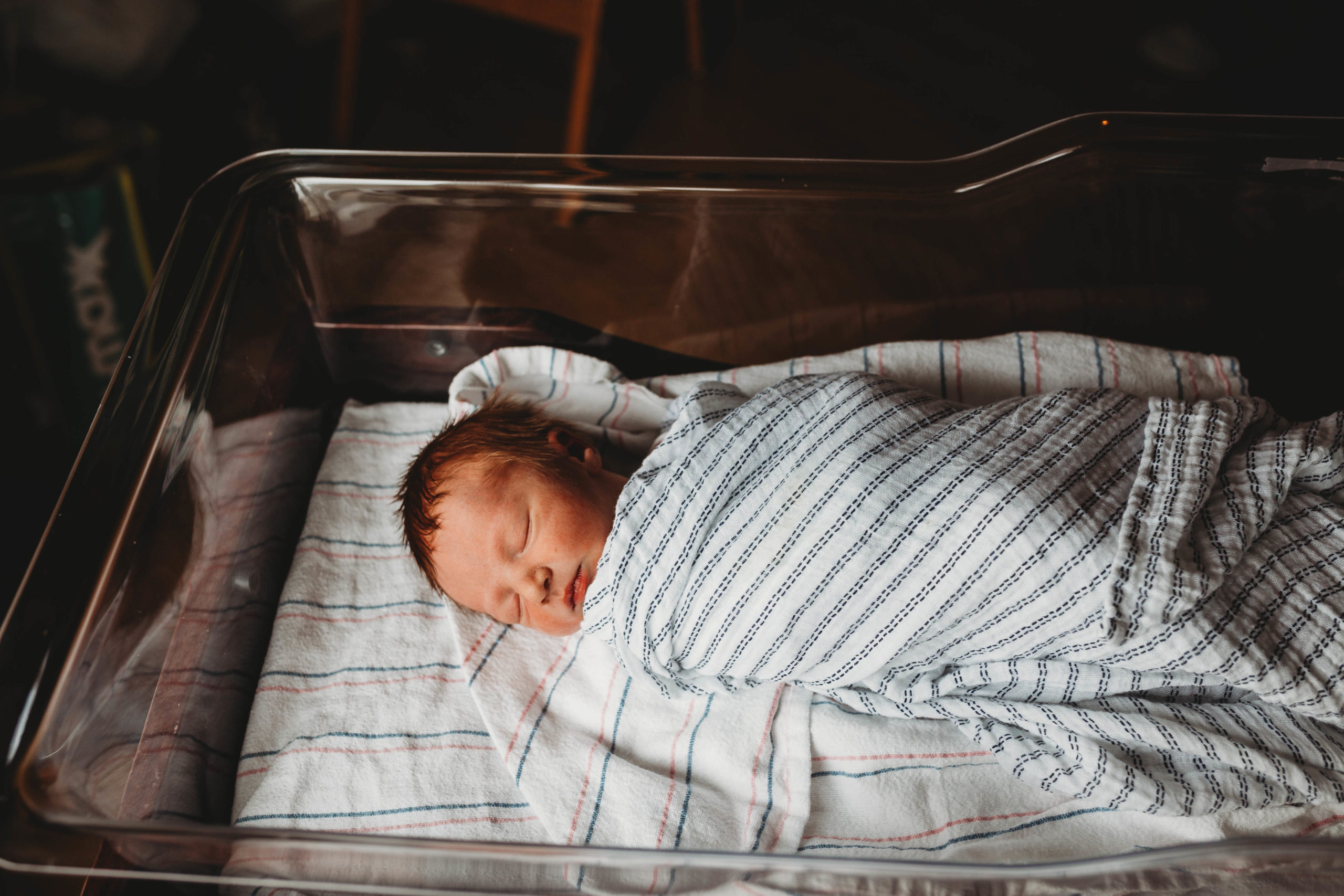 newborn sleeping in bassinet