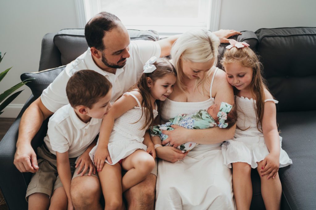 family looking at newborn