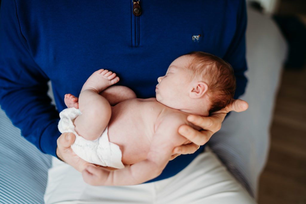 Dad holding baby during newborn session with baby born from Boston midwife